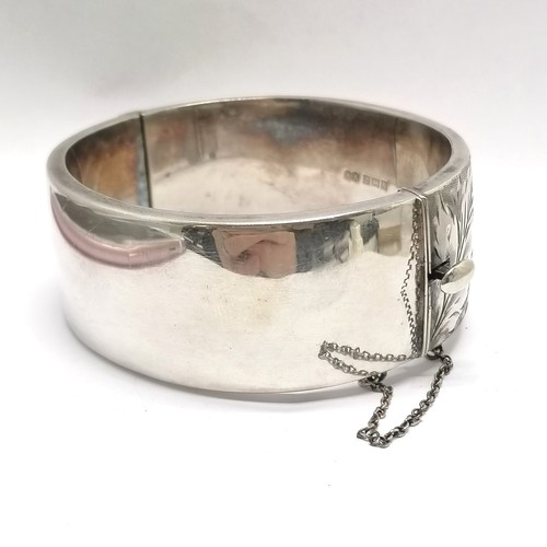 506 - Silver hallmarked bangle with engraved detail to front (24mm wide) by Ronex - 6cm internal diameter ... 