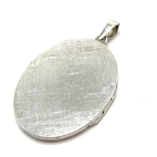 507 - Silver marked engraved oval locket - 5cm drop & 10.6g total weight ~ no obvious damage