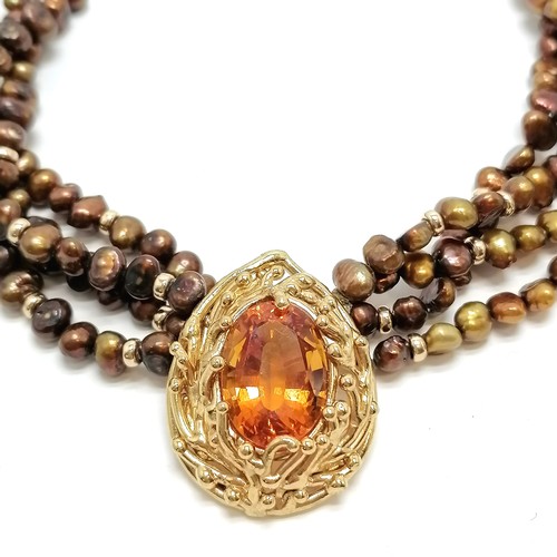 634 - 4 strand coloured pearl necklet with unmarked silver gilt pendant set with yellow stone - 42cm