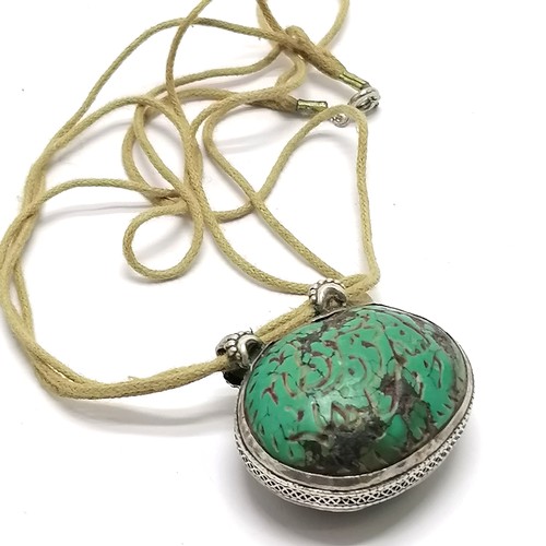 657 - Antique Islamic carved turquoise amulet set in unmarked silver with text to one side and a deer to t... 