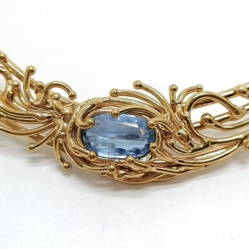 669 - Unmarked silver gilt collar set with blue topaz - 14cm across & 82g total weight