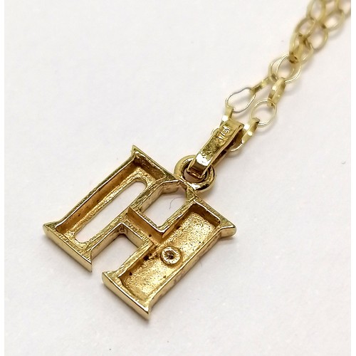 697 - 9ct marked gold H pendant set with a diamond on a 9ct marked gold 46cm chain - 1.2g total weight