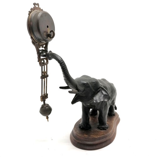 768 - Antique French bronze Elephant pendulum clock on a wooden base 28cm high - the pendulum is bent and ... 