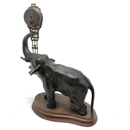 768 - Antique French bronze Elephant pendulum clock on a wooden base 28cm high - the pendulum is bent and ... 