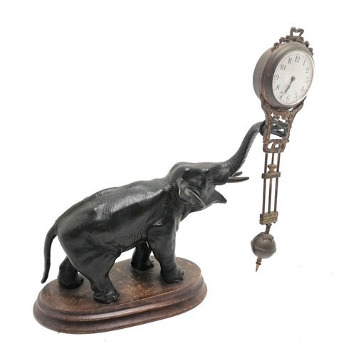 768 - Antique French bronze Elephant pendulum clock on a wooden base 28cm high - the pendulum is bent and ... 