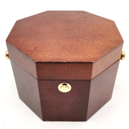 771 - Howard Miller quartz clock in an octagonal wooden box - 14.5cm x 14.5cm x 10.5cm & in used condition... 