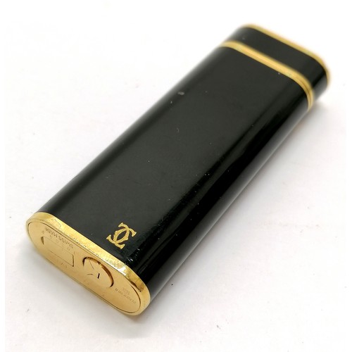 113 - Cartier Plaque Or G black enamel cigarette lighter - 7.1cm long & is in used condition