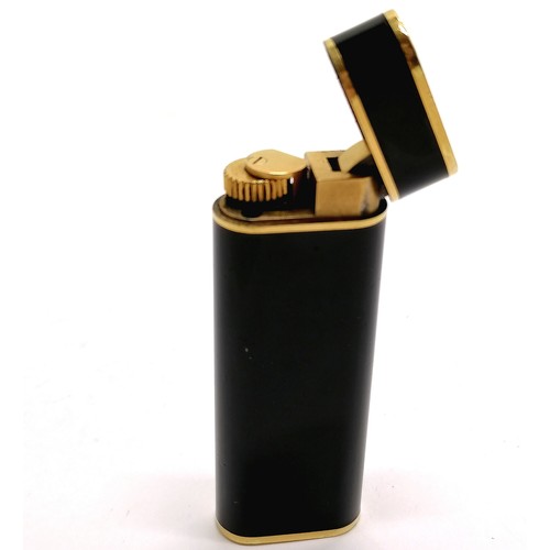 113 - Cartier Plaque Or G black enamel cigarette lighter - 7.1cm long & is in used condition