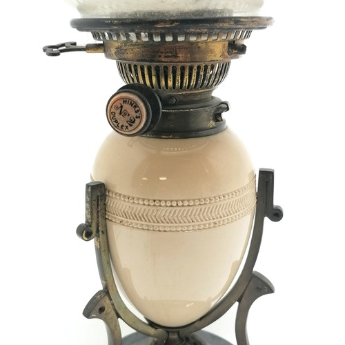 151 - Antique Art Nouveau oil lamp with a stoneware font in a stylised brass mount on a black ceramic base... 