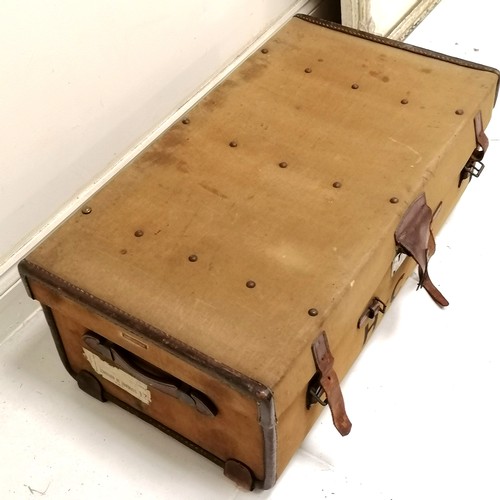 173 - Vintage canvas with leather mounted trunk, bears the initials H C W with original key and makers pla... 