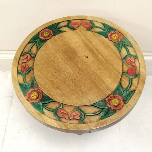 192 - Indian carved teak circular side table with carved floral decoration to top, the base having a carve... 