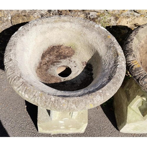 24 - Pair of garden concrete urns with fluted tops, resting on ecclesiastical inspired bases, 60 cm diame... 