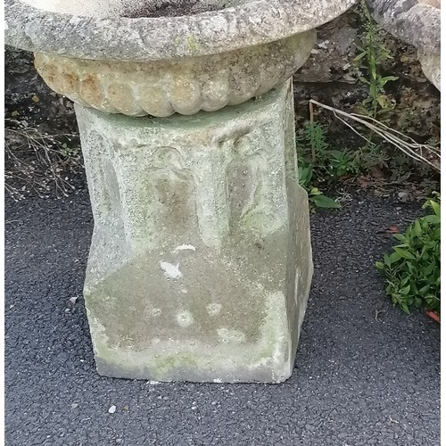 24 - Pair of garden concrete urns with fluted tops, resting on ecclesiastical inspired bases, 60 cm diame... 