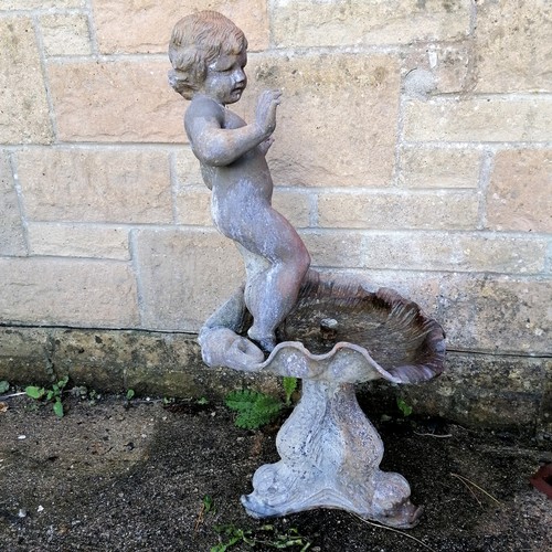 29 - Antique lead water feature of a putti figure standing on a shell above a dolphin base  total height ... 