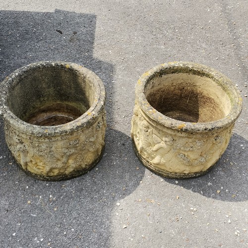 93 - Pair of concrete circular planters with putti detail 36cm high x 46cm diameter