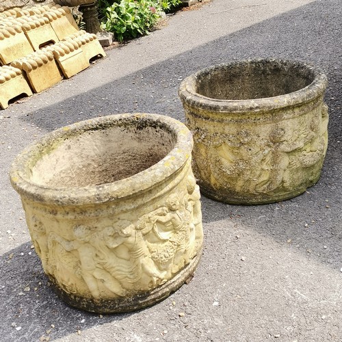 93 - Pair of concrete circular planters with putti detail 36cm high x 46cm diameter