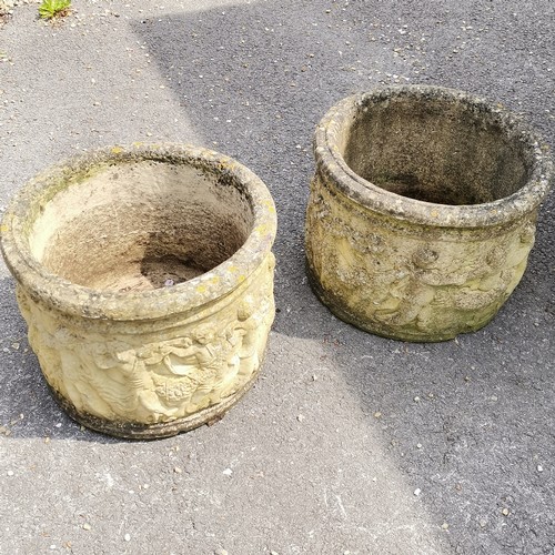 93 - Pair of concrete circular planters with putti detail 36cm high x 46cm diameter