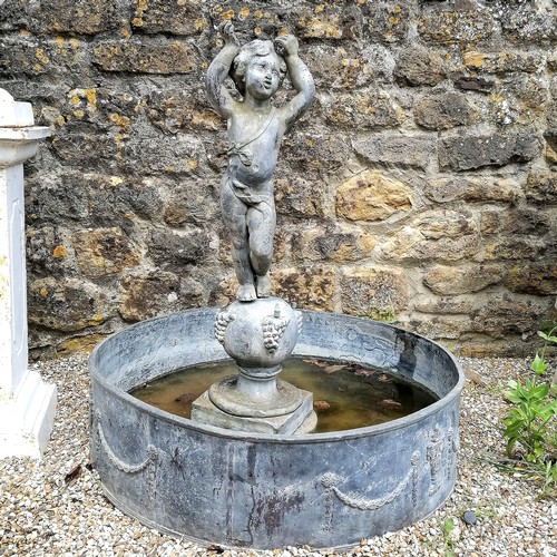 86 - Antique circular lead pond with swag decoration T/W a lead putti figure on a ball pedestal with 4 wa... 