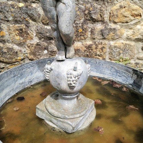 86 - Antique circular lead pond with swag decoration T/W a lead putti figure on a ball pedestal with 4 wa... 