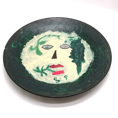 121 - Hand painted pottery charger with a white face design signed JP Portugal (on reverse) - 35cm diamete... 