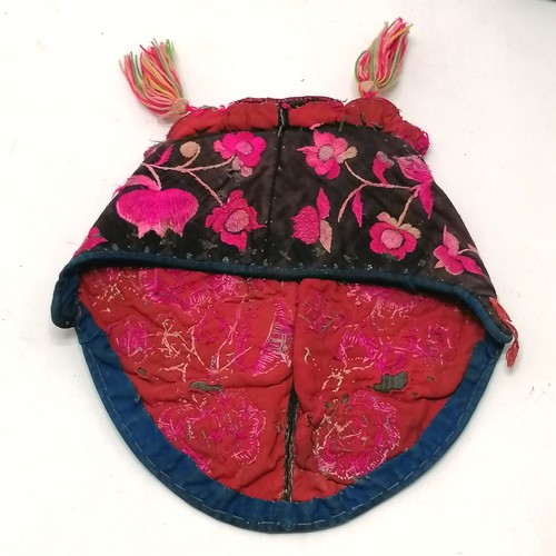 132 - Antique Chinese embroidered cloth hat pink decorated with flowers and has tassels - has signs of wea... 