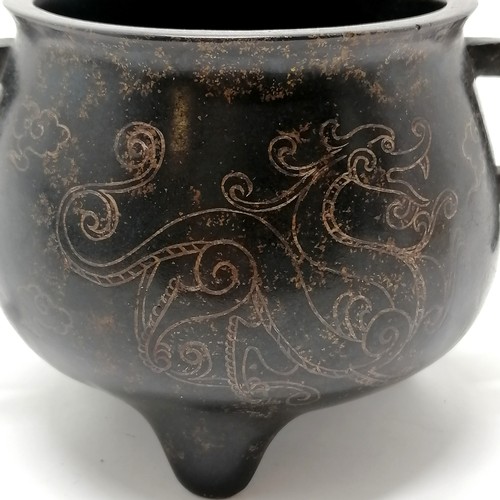 142 - Chinese antique bronze censer with silver inlaid dragon detail and 2 tag handles terminating on 3 fe... 