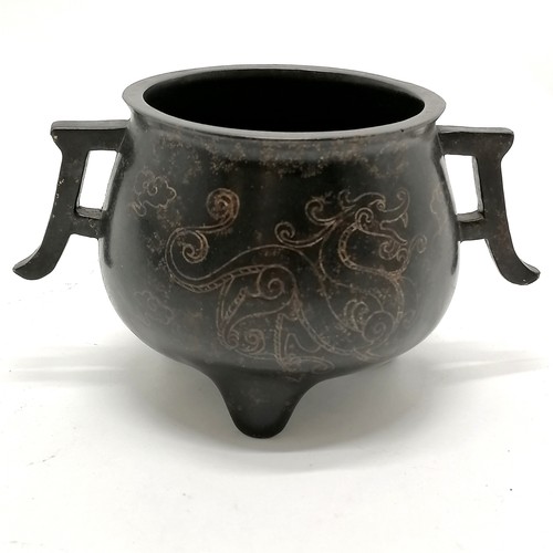 142 - Chinese antique bronze censer with silver inlaid dragon detail and 2 tag handles terminating on 3 fe... 