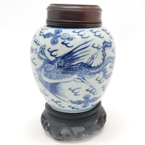 158 - Antique Chinese blue & white ginger jar with phoenix decoration and carved wooden lid on a wooden st... 