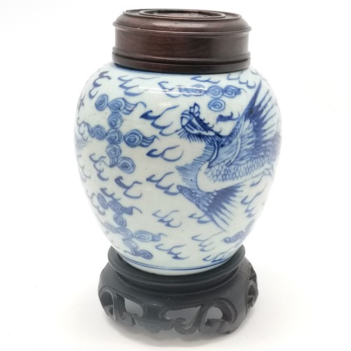 158 - Antique Chinese blue & white ginger jar with phoenix decoration and carved wooden lid on a wooden st... 