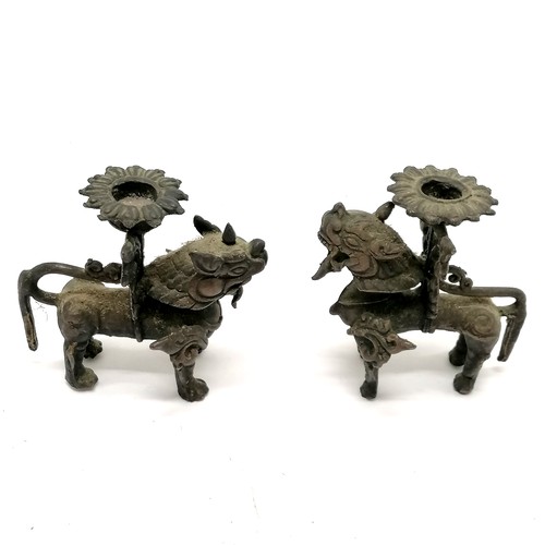 169 - Pair of Burmese lion dog bronze candlesticks - 9cm high with no obvious damage