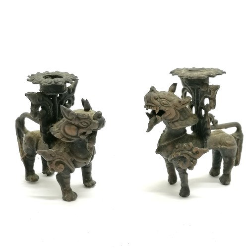 169 - Pair of Burmese lion dog bronze candlesticks - 9cm high with no obvious damage