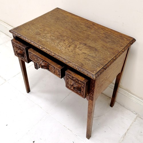 179 - Antique hand carved oak 3 drawer side table with green man cut handles & chip carved border to the t... 