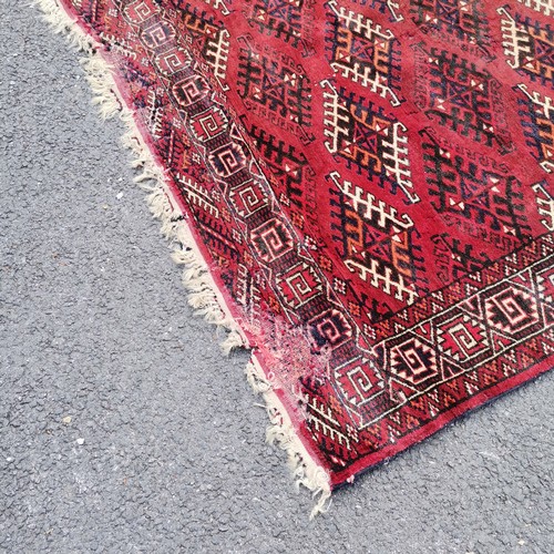 189 - Hand woven Eastern red grounded carpet with repeat geometric patterns - 215cm x 300cm - signs of mot... 