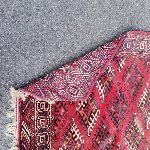 189 - Hand woven Eastern red grounded carpet with repeat geometric patterns - 215cm x 300cm - signs of mot... 