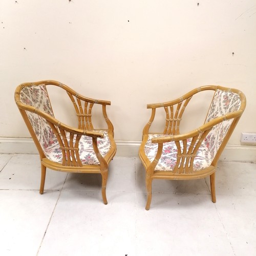 191 - Pair of faux bamboo conservatory chairs with floral design pattern upholstery - one lacks cushions -... 