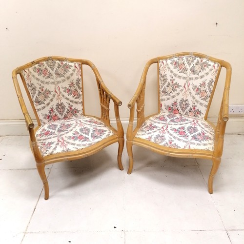 191 - Pair of faux bamboo conservatory chairs with floral design pattern upholstery - one lacks cushions -... 