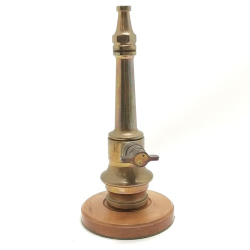 198 - H N Morris & Sons Ltd fire hose nozzle on turned wooden base with 1982 dedication - 34.5cm high