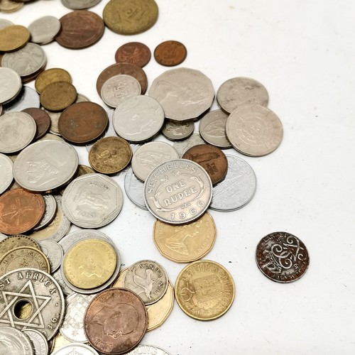 385 - Qty of mostly foreign coins in a shortbread tin