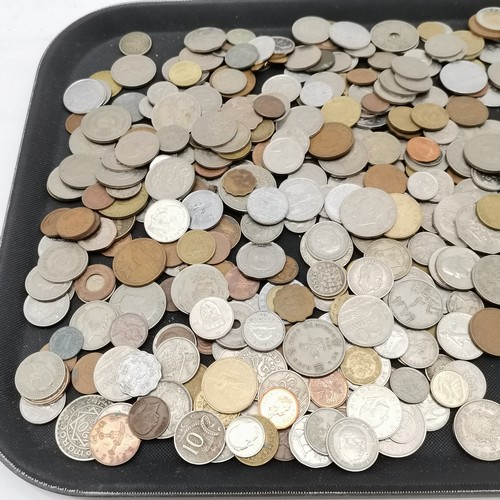 385 - Qty of mostly foreign coins in a shortbread tin