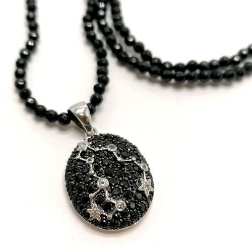 430 - Silver Pisces (constellation) pendant set with black / white stones on an 88cm faceted black bead ne... 