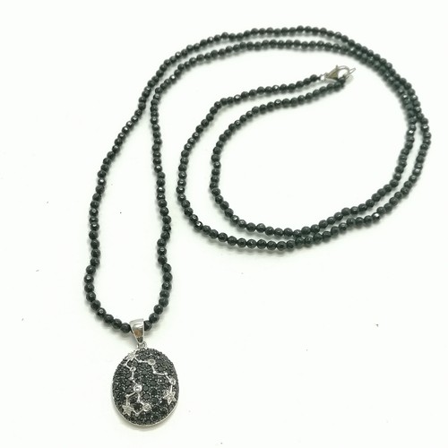 430 - Silver Pisces (constellation) pendant set with black / white stones on an 88cm faceted black bead ne... 