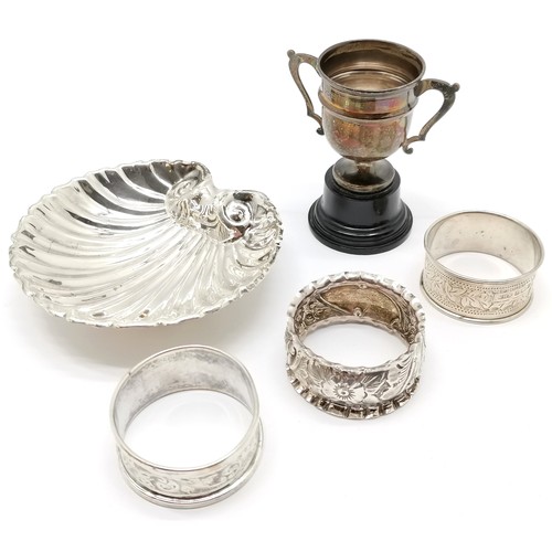 713 - Qty of silver - 3 napkin rings, shell butter dish & small trophy (by Viners) on bakelite base (7cm h... 
