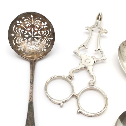 717 - Silver - scissor action sugar tongs with shell bowls, 2 caddy spoons & Victorian sifting spoon (12.5... 