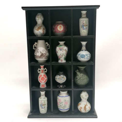 17 - Wooden ebonised display cabinet with 12 miniature Oriental vases - 40cm x 26cm x 9cm