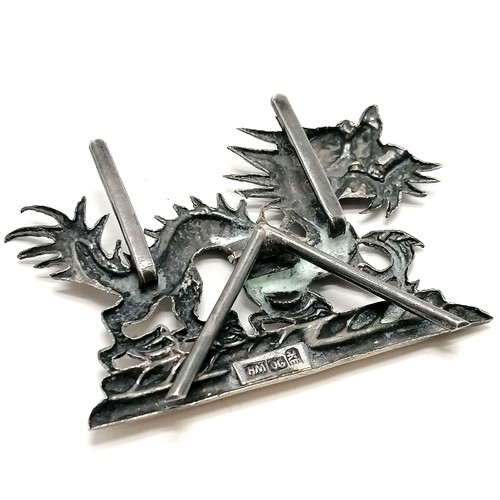 29 - Chinese silver dragon menu / card holder t/w unmarked silver napkin ring with dragon detail (4.5cm d... 