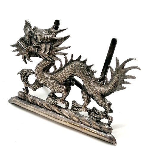 29 - Chinese silver dragon menu / card holder t/w unmarked silver napkin ring with dragon detail (4.5cm d... 