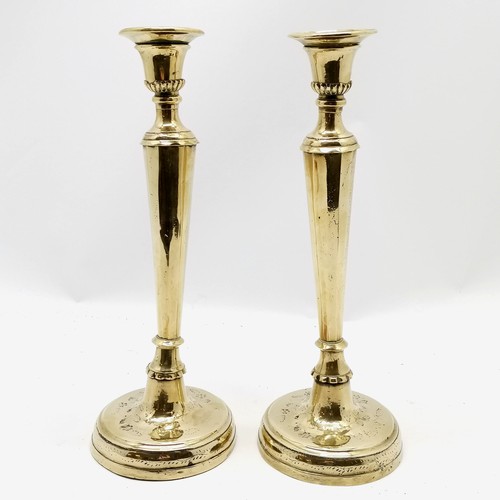 144 - Continental antique heavy cast pair of tall brass candlesticks 36cm high - decoration to the base is... 