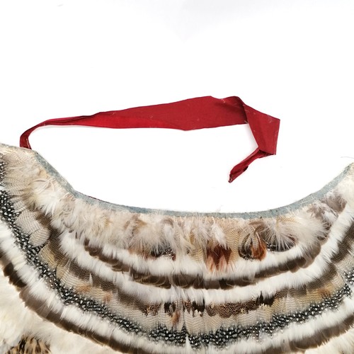 148 - Antique native American Indian feather cloak with red felt lining and pale blue cotton binding to th... 