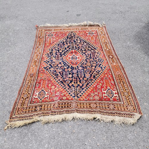 167 - Persian red grounded wool rug - 227cm x 150cm - in good used condition