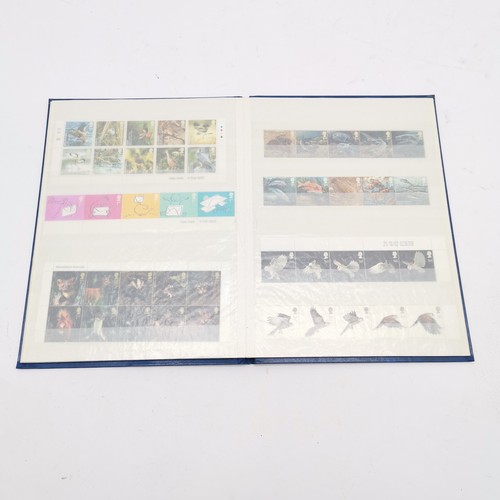 229 - Blue stockbook with UM/M (MNH) collection of GB 250 x 1st class stamps in blocks / strips FV £337.50